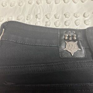 Men's Wornstar Black flair Jeans with studs on side of lower legs.